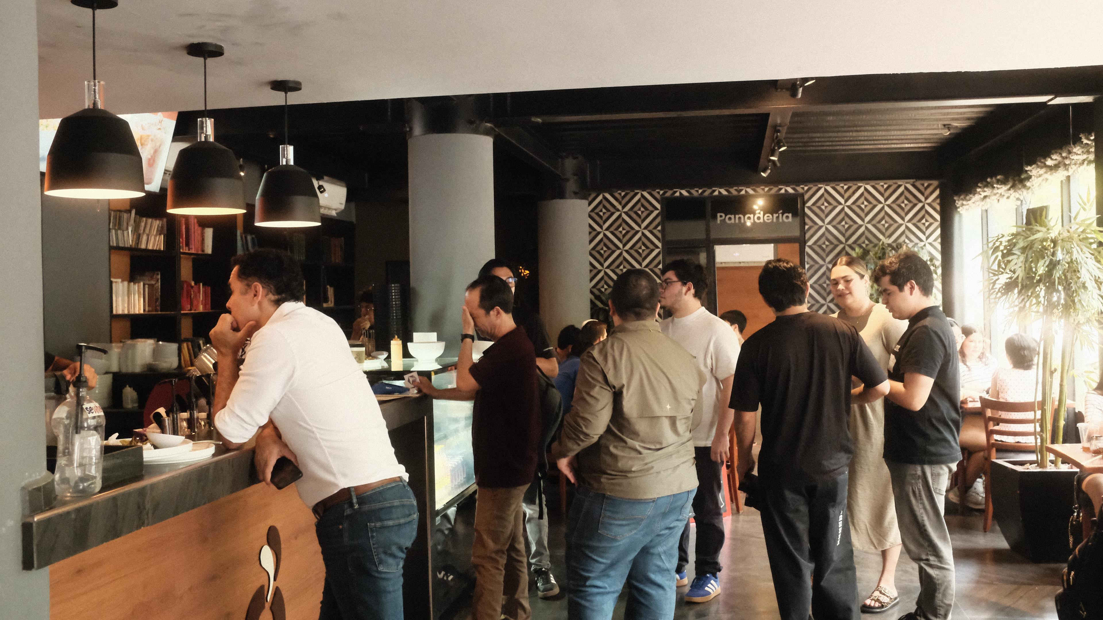 Community gathering in the cafe during Cafe Cursor Culiacán